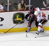 Warren Peters battles along the boards